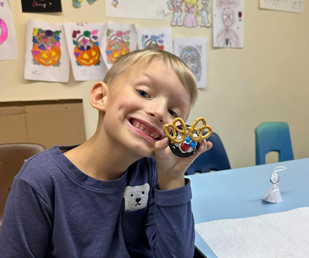 Boy holding up edible art